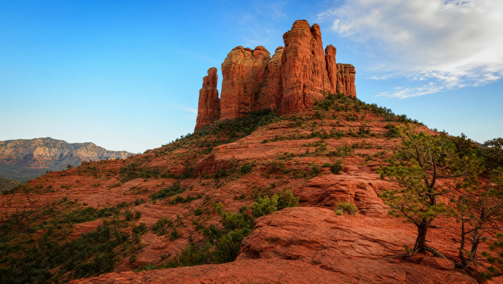 Hikers ascending the steep red sandstone trail at Cathedral Rock in Sedona, Arizona.
